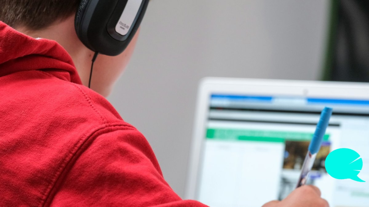 Persona estudiando inglés en una clase online individual con auriculares
